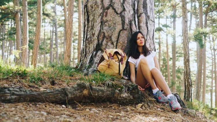 The girl undresses in the forest